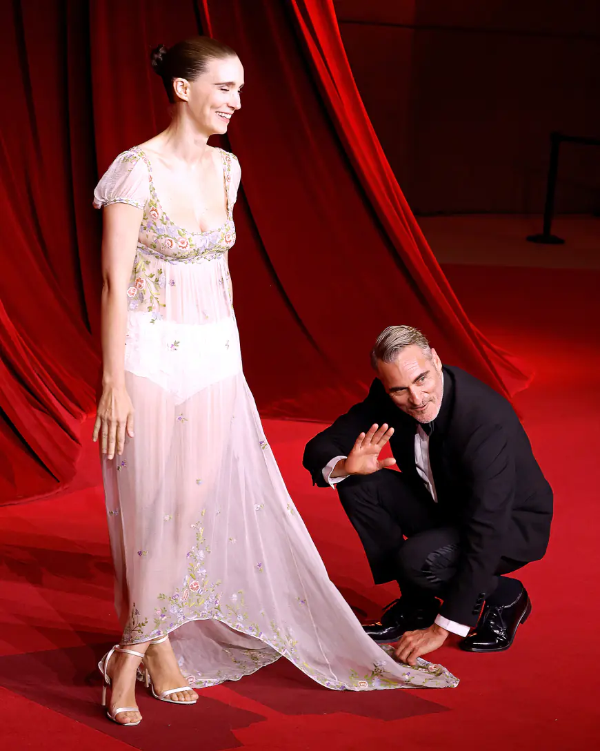 Joaquin Phoenix Sweetly Fixes Rooney Mara's Train at Academy Gala